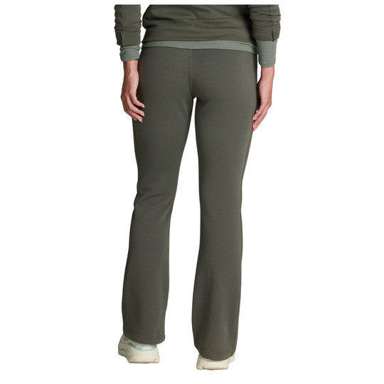 A person shown from the back wearing olive green pants and a matching long-sleeve top, standing against a plain white studio background.