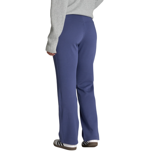 A person shown from the back wearing blue straight-leg sweatpants, a light gray ribbed sweater, and black-and-white sneakers against a plain white background.