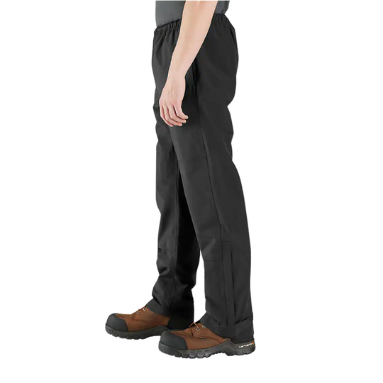A side profile view of a person wearing black work pants and brown work boots against a plain white background.