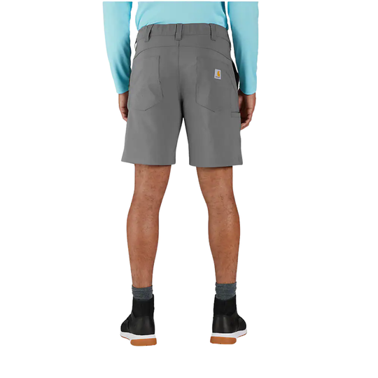 A person shown from the back wearing gray work shorts, a light blue long-sleeve shirt, gray socks, and black shoes against a plain white studio background.
