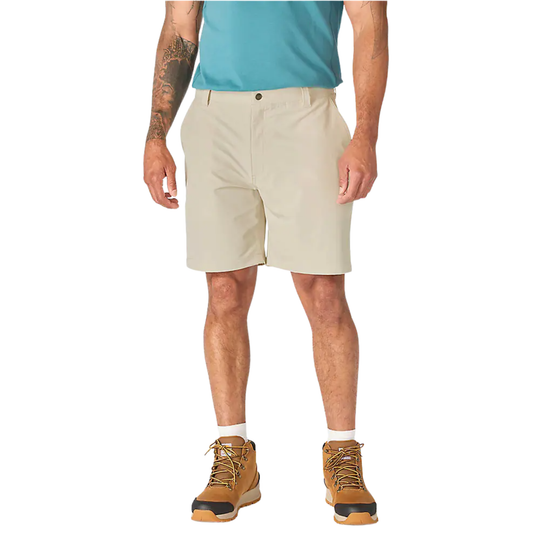 A model wearing beige athletic shorts, a teal t-shirt, white socks, and tan hiking boots, shown from the waist down on a solid white background.