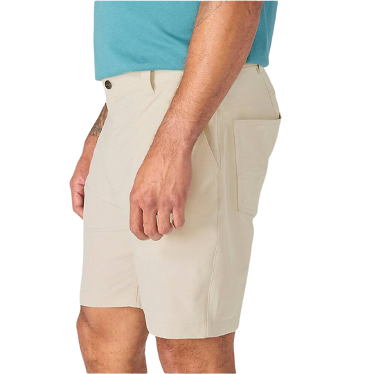 A side view of a person wearing light beige cargo-style shorts and a turquoise t-shirt against a plain white background.