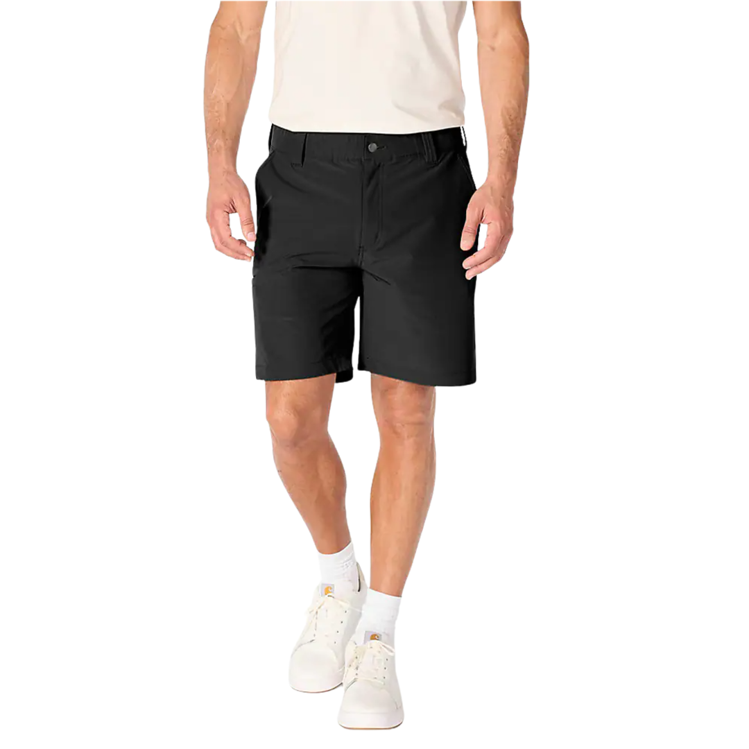 A man wearing black athletic shorts, a light beige t-shirt, white socks, and white sneakers, shown from the waist down on a solid white background.