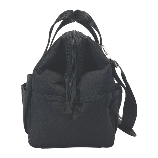 A black Carhartt tool bag with multiple front utility pockets, top carry handles, and a small Carhartt brand patch on the lower right front, shown against a plain white background.