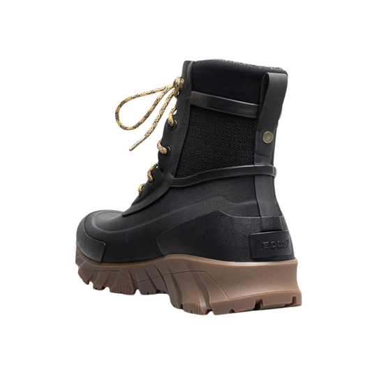 A single mid-calf waterproof boot in black with tan laces and a brown sole, shown in a side profile on a white background.