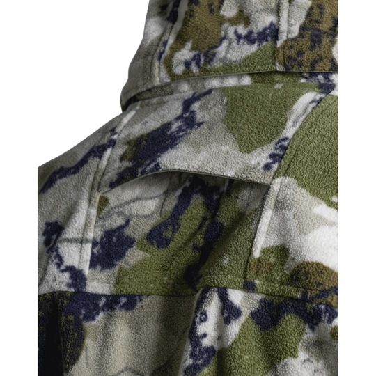 A hooded zip-up jacket in a digital camouflage pattern featuring olive green, beige, and dark navy/black shapes, shown on a plain white background.