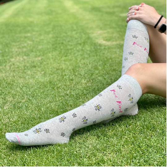 Dr. Motion Women's Bee's Knee High Compression Socks - Light Grey Heather on grass background