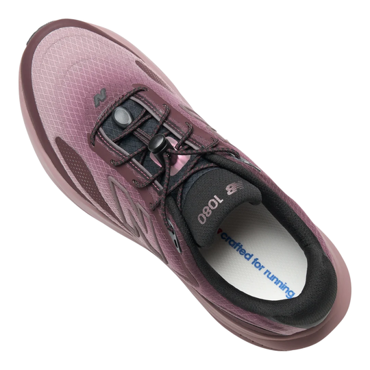 A New Balance running shoe in a dusty mauve and burgundy colorway, featuring a thick, cushioned pinkish-brown sole and a dark gray 'N' logo on the side, shown against a plain white background.