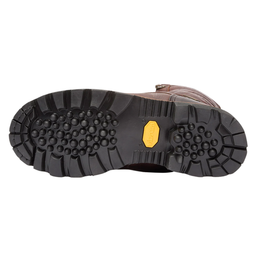 A close-up bottom view of a brown leather boot showing its black treaded rubber sole with a yellow Vibram logo patch in the center.