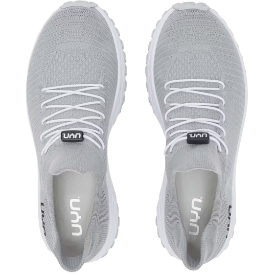 A pair of light gray knit athletic sneakers shown from a top-down view on a white background, featuring white laces and a black logo tab near the laces.