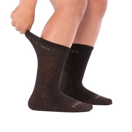 A pair of dark brown ribbed crew sock with a small beige logo near the cuff and a matching beige logo on the toe, shown against a plain white background.