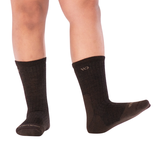 A pair of dark brown ribbed crew sock with a small beige logo near the cuff and a matching beige logo on the toe, shown against a plain white background.