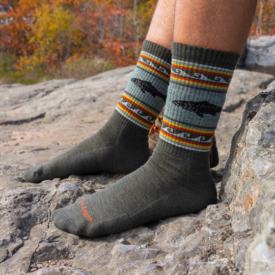 Darn Tough Vermont Men's VanGrizzle Midweight Hiker Boot Sock - Trout River pair on a male model on a rocky forest background