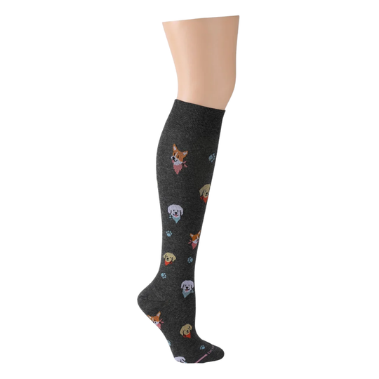 A single knee-high sock displayed on a mannequin leg against a plain white background. The sock is dark heather gray with a scattered pattern of small cartoon dog faces in various colors.