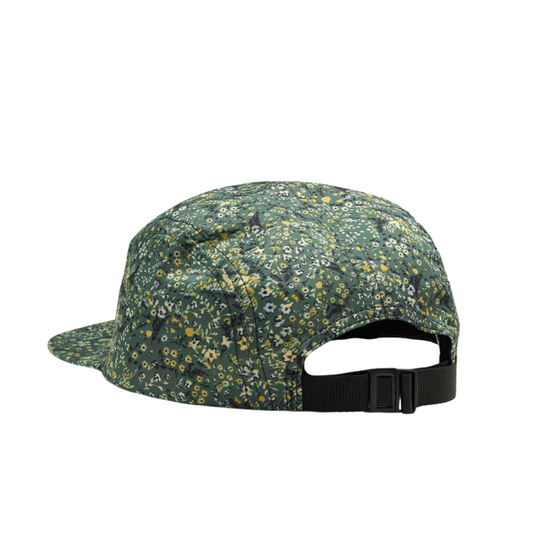 A five-panel cap shown from the back, featuring a dark green base with a dense yellow and white floral pattern, and a black adjustable strap with a plastic buckle.