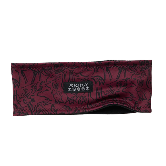 A maroon and black patterned headband with a black brand label reading SKIDA, shown against a plain white background.