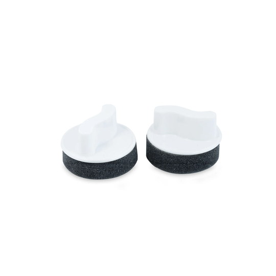 Two white and gray circular shoe polish daubers shown on a white background