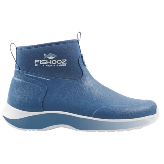 A blue ankle-high slip-on boot with a textured upper, elastic side panel, and a thick white and blue sole, shown from a side profile on a white background.