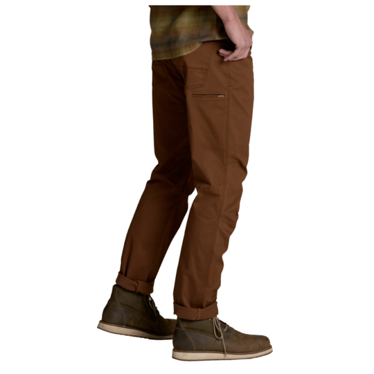 A person shown from the waist down wearing brown pants and brown boots against a plain white background.