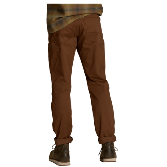 A person shown from the waist down wearing brown pants, a brown and green plaid shirt, and dark brown boots against a plain white background.
