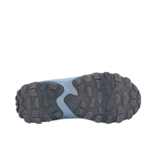 A close-up, top-down view of a shoe's rugged black outsole against a solid white background.