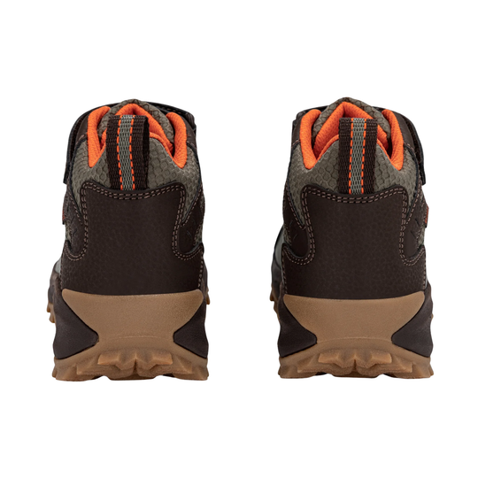 A pair of children's mid-height hiking boots shown from the back, featuring dark brown and gray textured panels with bright orange accents on the tongue lining and pull tabs, and tan rubber soles.