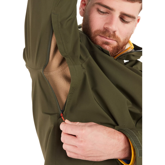 A close-up of a man wearing an olive green waterproof jacket, demonstrating a zippered sleeve that opens up to reveal a tan inner layer. He is pulling the zipper with his hand against a plain white background.