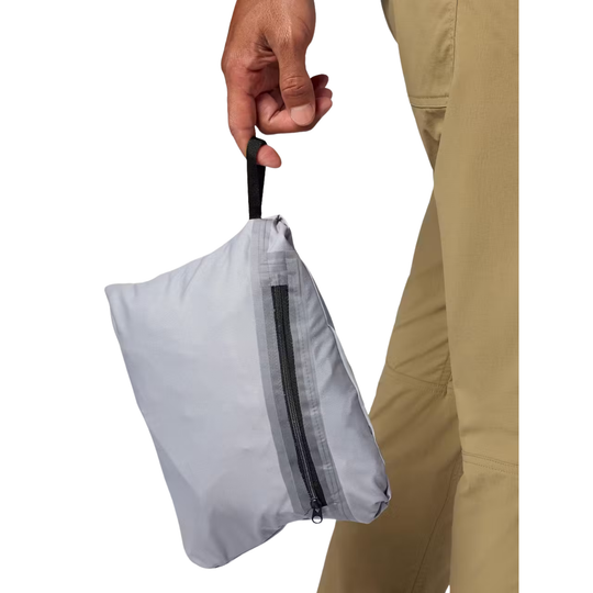 A person in tan pants holds a small light gray zippered pouch by a black loop handle against a plain white background.