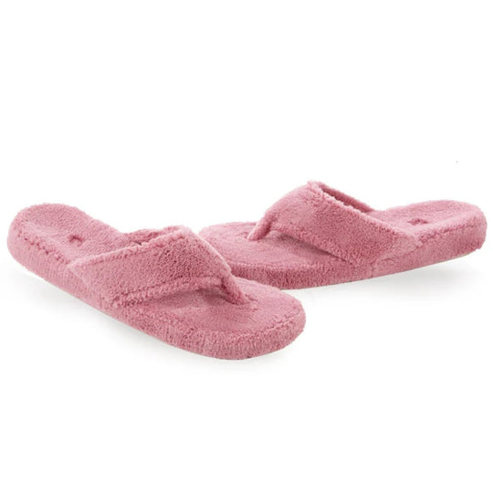 Pink fuzzy thong slippers on a white background