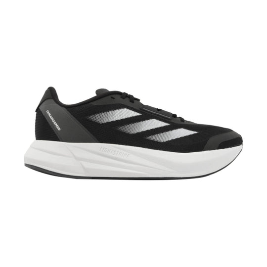 Black running shoe with thick white sole and three white side stripes