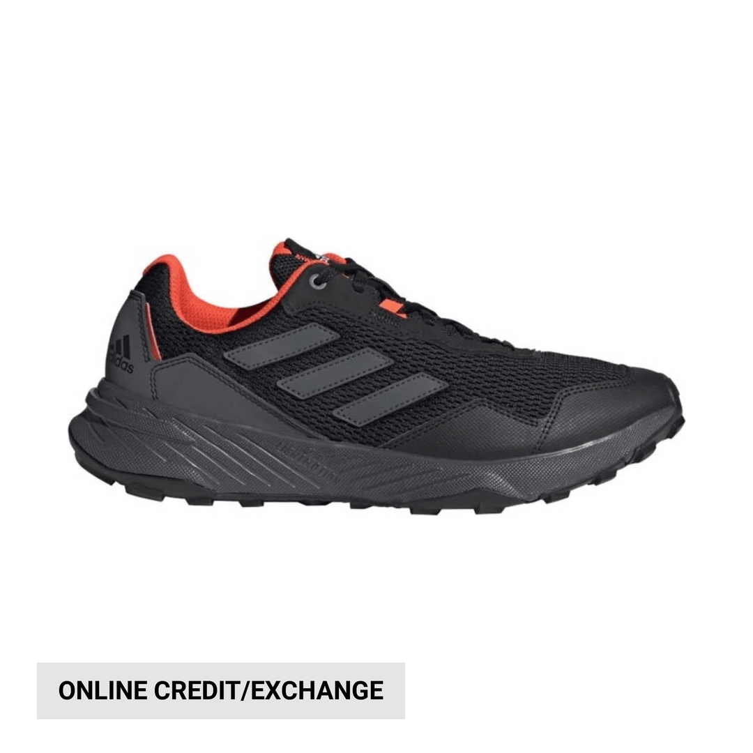 Black athletic trail shoe with gray stripes and red collar trim, side view