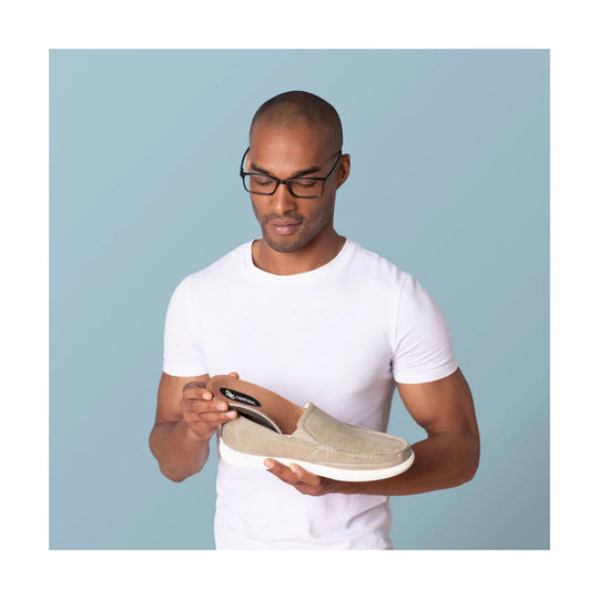 Beige slip-on shoe with white sole, shown with a removable insole