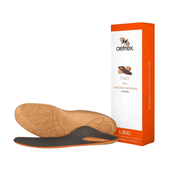 Pair of orthotic insoles with tan and black sides, shown in front of an orange-and-white box