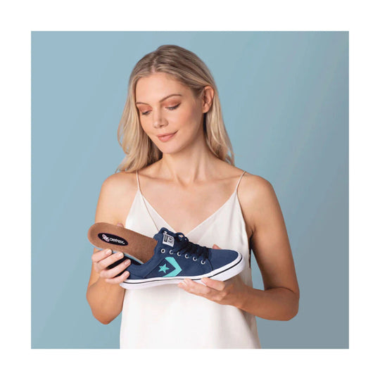 Blue canvas slip-on sneaker with white sole and side star logo, shown with the insole removed