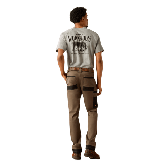 Back view of a gray graphic T-shirt with tan cargo work pants and brown work boots