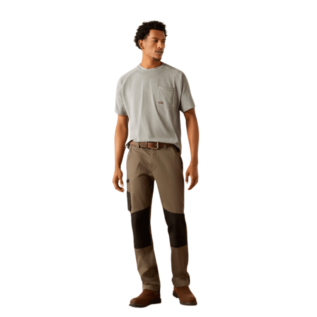 Man wearing gray short-sleeve pocket T-shirt with brown and black work pants and brown boots