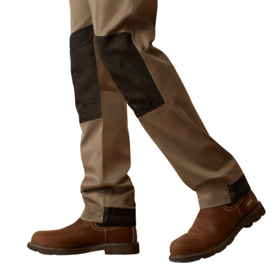 Tan cargo pants with black reinforced knee panels, shown with brown work boots