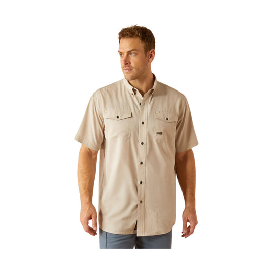 Beige short-sleeve button-up work shirt with dual chest pockets and a small logo patch