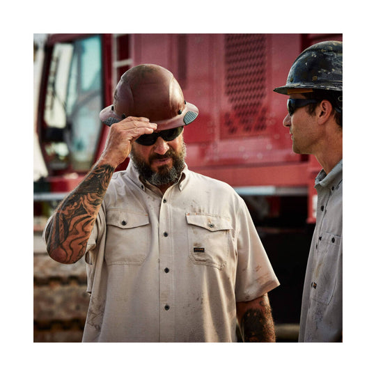 Light tan short-sleeve work shirt with chest pockets and Ariat logo patch