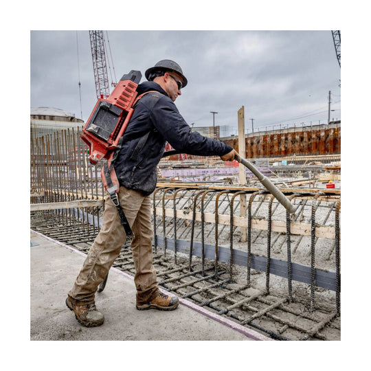 Black insulated work jacket on a worker at a construction site