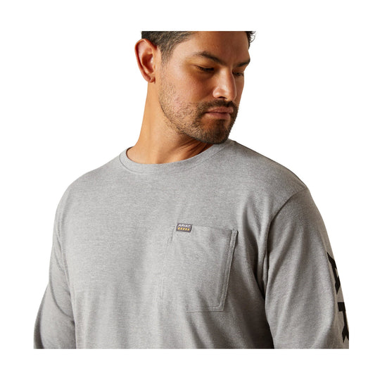 Light gray long-sleeve pocket T-shirt with a small chest logo patch and black sleeve graphic