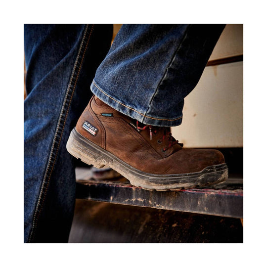 Brown leather lace-up work boot with a chunky treaded sole and visible Ariat patch