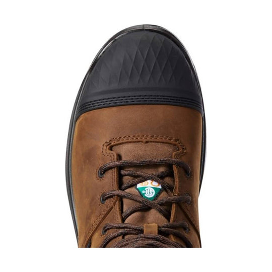 Brown lace-up work boot with a black rubber toe cap and small logo tag on the tongue