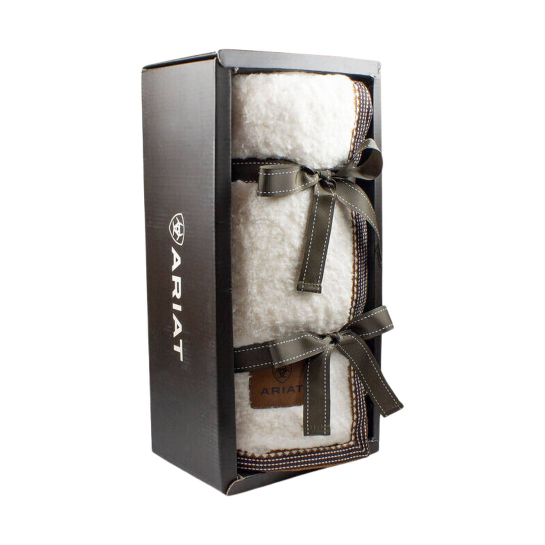 White fleece blanket in a dark gift box tied with brown ribbons