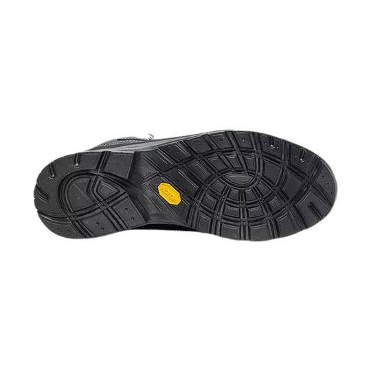 Black hiking boot outsole with deep tread and a yellow traction badge
