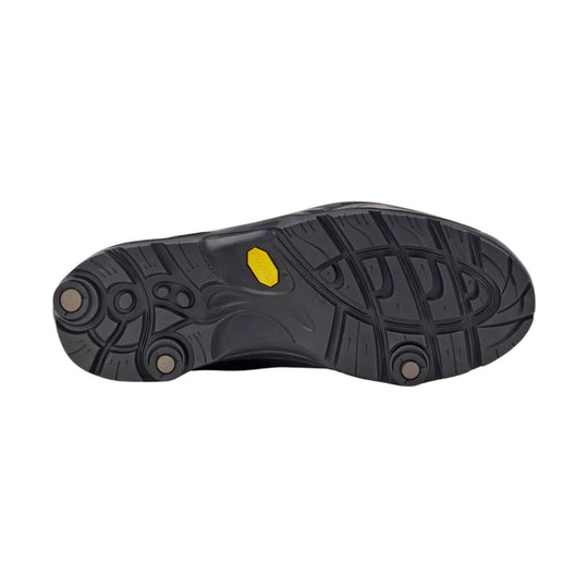 Black hiking boot outsole with deep tread and a yellow Vibram badge