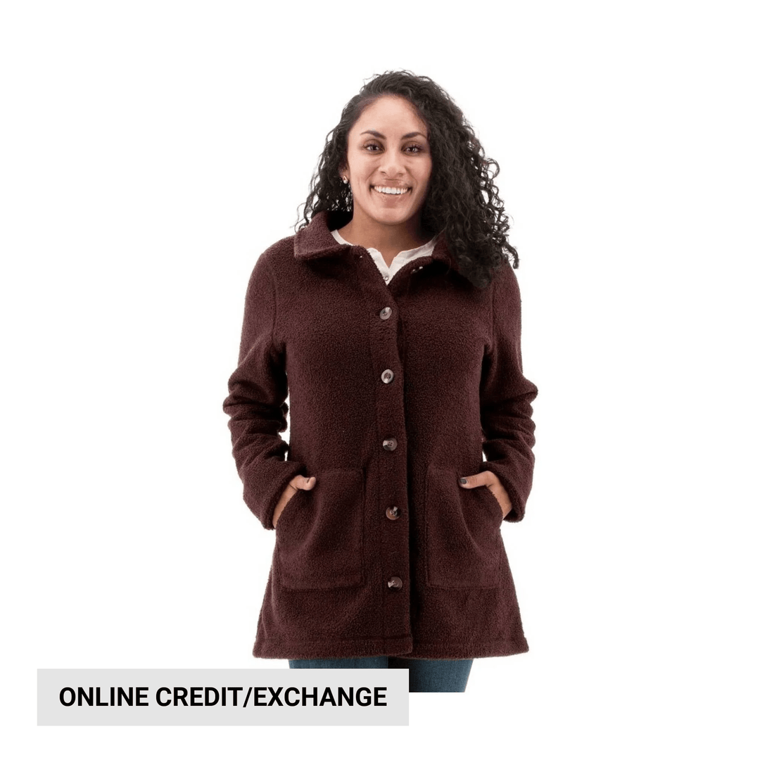 Brown textured button-front coat with large patch pockets and lapel collar, worn over a white top