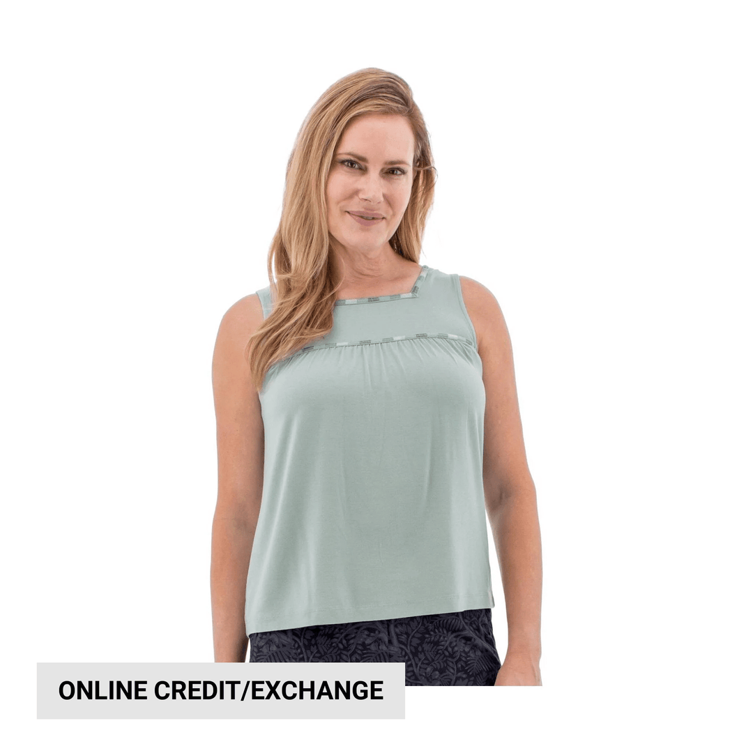 Light green sleeveless tank top with a square neckline and loose fit, shown with dark patterned shorts