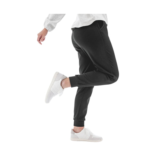 Black fleece joggers with tapered cuffs, shown on a model with white sneakers
