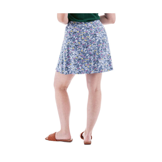 Blue floral swing skort with a flared hem, worn with a dark green top and brown slide sandals
